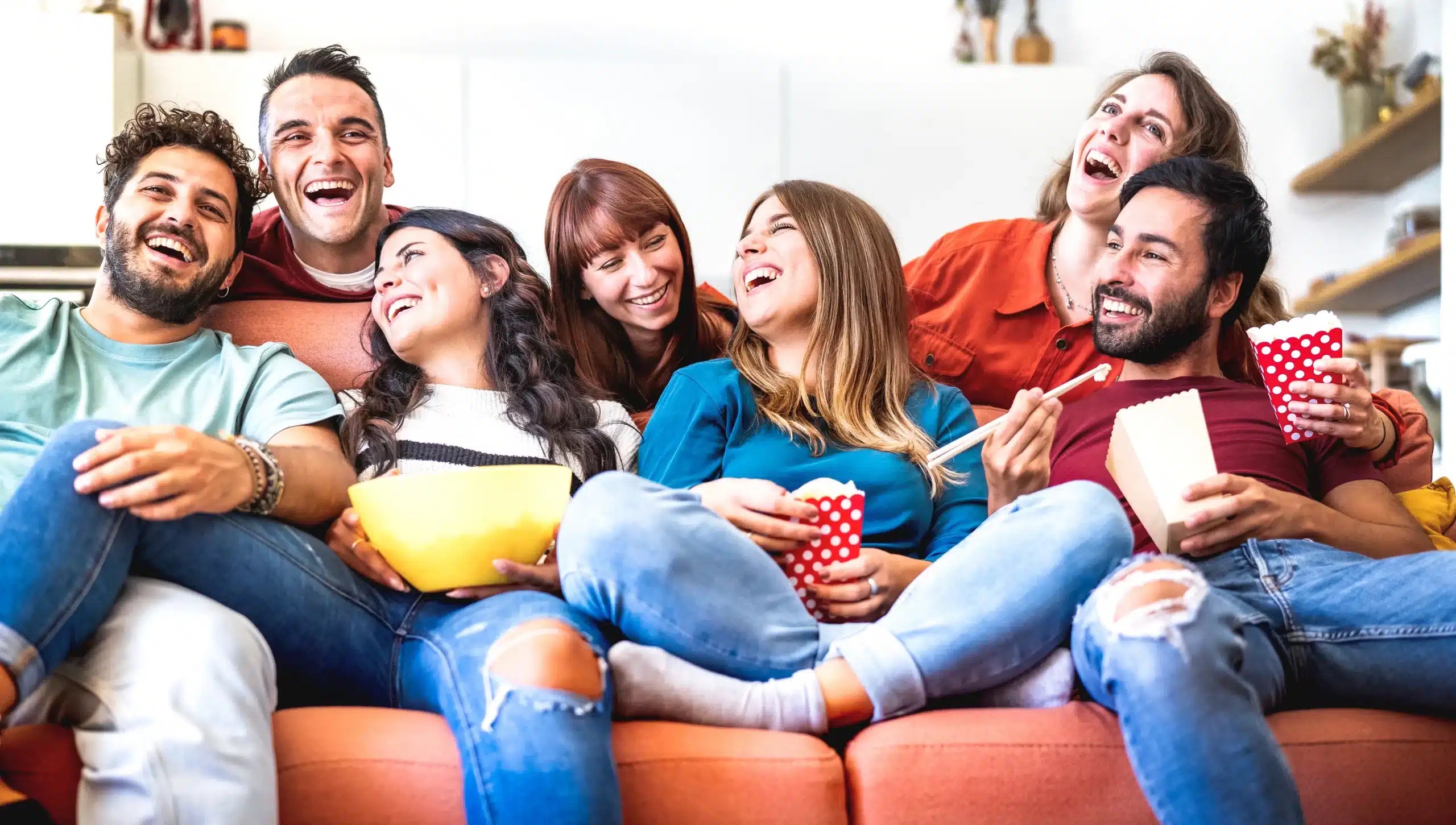 young-friends-having-genuine-fun-together-home-watching-movie-smart-tv-scaled